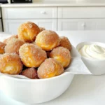 To make these yummy bites, gather the following: - 1 cup warm water (between 110°F - 115°F) - 2 tablespoons granulated sugar - 2 teaspoons active dry yeast - 2 ½ cups all-purpose flour - 1 teaspoon salt - ¼ cup baking soda - 1 large egg, beaten (for egg wash) - ½ cup unsalted butter, melted - ½ cup granulated sugar (for cinnamon sugar coating) - 2 teaspoons ground cinnamon These ingredients work together to create soft, sweet pretzel bites. The warm water helps activate the yeast. Sugar gives the dough a slight sweetness. The flour and salt form the base of the pretzel bites. Baking soda adds that classic pretzel flavor, while the melted butter makes them rich and tasty. For the perfect dip, you will need: - 4 oz cream cheese, softened to room temperature - ¼ cup powdered sugar - 2 tablespoons sour cream - 1 teaspoon pure vanilla extract - A pinch of salt This dip is simple but so good! Cream cheese creates a smooth base. Powdered sugar adds sweetness, while sour cream gives it a nice tang. Vanilla adds depth, and a pinch of salt balances all the flavors. To make these pretzel bites, you will need: - Mixing bowls - Whisk - Slotted spoon - Parchment paper - Baking sheet - Rolling pin - Knife Having the right tools helps you cook with ease. Mixing bowls are great for combining ingredients. A whisk mixes the dry and wet items well. A slotted spoon allows you to lift the bites from boiling water easily. Parchment paper ensures easy cleanup, while a baking sheet holds your pretzel bites in the oven. A rolling pin and knife help shape the dough for perfect bites. To start, grab a medium bowl. Combine 1 cup of warm water, 2 tablespoons of granulated sugar, and 2 teaspoons of active dry yeast. Stir it gently. Let it sit for about 5 minutes. It should become bubbly and frothy. This means the yeast is ready to work. Next, take a large mixing bowl. Whisk together 2 ½ cups of all-purpose flour and 1 teaspoon of salt. Pour the activated yeast mixture into the flour mix. Stir until it forms a dough. Then, place the dough on a lightly floured surface. Knead it for about 5 minutes until smooth. Put the dough in a greased bowl. Cover it with a damp cloth. Let it rise in a warm spot for about 1 hour. It should double in size. After the dough has risen, gently punch it down. Turn it out onto a floured surface and roll it into a log. Cut the log into 1-inch pieces for bite-sized pretzel bits. In a large pot, bring 10 cups of water to a boil. Carefully add ¼ cup of baking soda. The mixture will bubble, so watch out! Reduce the heat so it simmers. Drop 6 pretzel bites at a time into the water. Boil each batch for 30 seconds. Use a slotted spoon to remove them and place them on a baking sheet. Preheat your oven to 425°F (220°C). Brush the tops of the pretzel bites with a beaten egg. This gives them a nice golden color. Mix ½ cup granulated sugar and 2 teaspoons of ground cinnamon in a bowl. Sprinkle this cinnamon sugar over each pretzel bite. Bake them in the oven for 12-15 minutes until they are golden brown and smell amazing. While the pretzel bites bake, it's time for the cream cheese dip. In a bowl, beat together 4 oz of softened cream cheese, ¼ cup powdered sugar, 2 tablespoons sour cream, 1 teaspoon pure vanilla extract, and a pinch of salt. Mix until it's smooth and creamy. Now your warm pretzel bites and delicious cream cheese dip are ready to enjoy! To get the best texture for your pretzel bites, focus on the dough. Kneading is key. Knead the dough for about five minutes until it feels smooth and elastic. This helps develop the gluten, giving your bites that perfect chewy bite. Don't skip the boiling step! Boiling in a baking soda solution helps the bites achieve that classic pretzel crust. Bake them until golden brown for that delightful crunch. Cinnamon sugar pretzel bites are great for sharing! Serve them warm in a basket lined with parchment paper. Add a bowl of cream cheese dip in the center. This makes for a fun dip-and-enjoy experience. Create a pretzel bar with different dips, like caramel or chocolate, for even more fun. Guests will love the hands-on approach! For your cream cheese dip, a little garnish goes a long way. A light dusting of cinnamon on top adds visual appeal. You can also add some crushed nuts for crunch. Fresh fruit, like berries, can brighten the dish and add flavor. Arrange these garnishes neatly for a beautiful presentation. {{image_4}} You can switch up the flavor by changing the coating on your pretzel bites. Instead of cinnamon sugar, try using: - Chocolate: Melted dark or milk chocolate adds a rich taste. - Caramel: Drizzle warm caramel on top for a sweet twist. - Sprinkles: Use colorful sprinkles for a fun party treat. These variations let you create something new every time. If sweet isn't your thing, go savory! Consider these options: - Cheese: Sprinkle grated Parmesan or cheddar before baking. - Garlic: Toss crushed garlic with melted butter and brush over the bites. - Herbs: Mix dried herbs like oregano or rosemary into the dough for extra flavor. Savory pretzel bites are great for snacking or as an appetizer. You can enjoy your pretzel bites with more than just cream cheese dip. Here are some tasty options: - Mustard: A tangy mustard dip adds a nice kick. - Cheese Sauce: Warm cheese sauce is perfect for cheese lovers. - Yogurt Dip: Mix yogurt with herbs and spices for a fresh option. These dips enhance the pretzel experience and suit different tastes. To keep your pretzel bites fresh, let them cool completely first. Place them in an airtight container. You can also wrap them in plastic wrap. They will stay good on the counter for 2-3 days. If you want to keep them longer, consider freezing. When you’re ready to enjoy your leftover pretzel bites, reheating is key. Preheat your oven to 350°F. Place the bites on a baking sheet. Heat them for about 5-10 minutes. This helps them stay soft and warm. You can also use a microwave. Heat for about 15-20 seconds, but they may get chewy. Freezing is a great option if you made too many. Once the bites cool, place them in a single layer on a baking sheet. Freeze for about 1 hour. Then, transfer them to a freezer bag. They can last up to 3 months in the freezer. When you’re ready to eat, just bake them straight from the freezer. Enjoy the warm, fresh taste all over again! To make pretzel bites less chewy, you can adjust the kneading time. Knead the dough for just 3-4 minutes instead of 5. This keeps the gluten from forming too much. You can also use bread flour, which creates a chewier texture. Lastly, avoid over-boiling the bites. Boil them for only 30 seconds for a lighter texture. Yes, you can use instant yeast instead of active dry yeast. Instant yeast works faster and does not need to be activated. Just add it directly to the flour mixture. However, reduce the water slightly since instant yeast absorbs moisture better. You can keep the cream cheese dip for up to 5 days in the fridge. Store it in an airtight container to keep it fresh. If you notice any changes in smell or texture, it’s best to toss it out. If you need a substitute for sour cream, you can use Greek yogurt. It has a similar tangy flavor and creamy texture. You can also use buttermilk or plain yogurt as alternatives. Just make sure to adjust the amount to get the desired consistency. You learned how to make tasty cinnamon sugar pretzel bites and creamy dip. I shared tips to help you get great texture and tasty flavors. Don’t forget serving ideas and variations to impress friends. Storing and reheating can keep them fresh for later. Explore your options and have fun with this snack. Enjoy each bite and be creative with your twists!