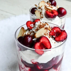 You can use either fresh or frozen cherries for this dessert. If you choose fresh cherries, make sure they are ripe and sweet. You will need 2 cups of cherries, pitted and halved. Frozen cherries are a great option too. They are easy to use and save time. If you pick frozen, allow extra time to heat them through. For sweetness, we add 1/2 cup of granulated sugar. This sugar helps the cherries create a lovely syrup. To enhance the flavor, add 1 tablespoon of freshly squeezed lemon juice and 1 teaspoon of pure vanilla extract. The lemon adds a nice zing, while the vanilla gives warmth to the dish. You will need 1 cup of heavy whipping cream. This cream is key to making the dessert light and fluffy. Whip it until it holds stiff peaks. For added sweetness, mix in 1/2 cup of powdered sugar and 1 teaspoon of almond extract. To finish, top each serving with 1/4 cup of toasted slivered almonds and a sprinkle of fluffy shredded coconut. These garnishes not only taste great but also look beautiful, mimicking snow on cherries. {{ingredient_image_2}} Start by pitting and halving your cherries. You can use fresh or frozen cherries. In a medium saucepan, mix the cherries, granulated sugar, lemon juice, and vanilla extract. Heat it on medium. Stir this mix often. Cook until the cherries soften and the mix thickens, about 8-10 minutes. If you use frozen cherries, it may take longer. Once it thickens, remove it from heat. Let it cool to room temperature. This cooling time helps the flavors blend. While the cherry mix cools, take a large mixing bowl. Pour in the heavy whipping cream. Use an electric mixer to whip the cream. Beat it until you see soft peaks form. Slowly add the powdered sugar and almond extract. Keep whipping until the cream is thick and holds its shape. This whipped cream will add a light, fluffy texture to your dessert. Grab some clear serving glasses or bowls. To start, spoon a layer of the cherry mixture into the bottom of each glass. Next, add a generous layer of whipped cream. Repeat these layers until you use all the cherry mix and cream. Make sure the top layer is whipped cream. To finish, sprinkle each dessert with toasted slivered almonds and some fluffy shredded coconut. This will make it look like snow on cherries. Finally, chill the desserts in the fridge for at least one hour. This time allows the flavors to mix well and helps the dessert firm up. To make the best whipped cream, start with cold heavy cream. Cold cream whips better. Use a clean bowl and beaters. This helps the cream whip fast. Whip until soft peaks form, then add powdered sugar and almond extract. Keep whipping until you see stiff peaks. Stiff peaks hold their shape well. This cream will top your dessert perfectly. You can boost the flavor of your cherries. Try adding a splash of orange juice for bright notes. A pinch of cinnamon can add a warm touch. If you like a bit of spice, a dash of nutmeg works well too. For a more complex flavor, consider adding a splash of cherry liqueur. This makes the dessert even more special and festive. Presentation makes a difference. Use clear glass cups to show off the layers. This makes it look beautiful. Top with slivered almonds and a sprinkle of coconut. This adds texture and a snowy look. A sprig of mint can brighten the dish. It adds color and a fresh scent. The right presentation makes your dessert shine. Pro Tips Use Fresh Cherries: For the best flavor and texture, opt for fresh cherries when in season. They will enhance the overall taste of the dessert significantly. Chill the Cream: Ensure your heavy whipping cream is very cold before whipping. This helps achieve the best volume and stiffness for your whipped cream. Layering Technique: When layering the dessert, start with cherries and finish with whipped cream to create a visually appealing presentation. Garnish Ideas: Experiment with different garnishes like crushed pistachios or a drizzle of chocolate sauce for a unique twist on the classic presentation. {{image_4}} You can switch out cherries for other fruits. Strawberries add a sweet touch. Peaches bring a nice summer flavor. Blueberries add a pop of color and taste great, too. You can even mix different fruits for a fun twist. Think about your favorite fruits and try them in this dessert. While heavy cream makes this dessert rich, you can try other creams. Coconut cream offers a dairy-free option. It adds a lovely tropical taste. Greek yogurt gives a tangy flavor and adds protein. You can also use whipped topping for a lighter version. Just ensure it holds its shape well. Serve Cherries in the Snow in clear cups to show off the layers. A sprig of mint on top adds color and freshness. You can also pair this dessert with shortbread cookies for extra crunch. Another idea is to serve it alongside vanilla ice cream for a creamy contrast. Each serving can be a bit different based on your choices! To keep your Cherries in the Snow fresh, store leftovers in an airtight container. Place it in the fridge. This helps the dessert stay cool and tasty. Make sure to consume the dessert within three days for the best flavor. If the whipped cream starts to weep, it may not taste as good. You don&rsquo;t need to reheat this dessert. Cherries in the Snow is best served cold. If you want to enjoy it warm, you can gently heat the cherry mixture on the stove. Just warm it up slowly on low heat. Stir it often, so it doesn&rsquo;t burn. Serve the warm cherry mix over the chilled whipped cream if you like a warm twist. Fresh cherries last about a week in the fridge. If you use frozen cherries, they can stay good for months in the freezer. Heavy cream lasts about a week after opening. Always check the date on the container. If any ingredient looks or smells off, it&rsquo;s best to throw it away. Keeping an eye on your ingredients ensures that your dessert tastes its best! Yes, you can use frozen cherries. They work well and provide great flavor. Just remember to cook them a bit longer. This allows them to become tender and warm. Follow the same steps as with fresh cherries. The key is to ensure they heat through and create a nice syrup. You can store Cherries in the Snow for about three days in the fridge. Just keep it covered to prevent drying out. The flavors get better as it sits, but the whipped cream may lose some texture. If you want the best taste, serve it fresh. If you need a substitute for heavy cream, you can use coconut cream or whipped coconut milk. Both options add a rich taste. They also work well in recipes for a dairy-free option. Just make sure to whip it until you get the right consistency. In this blog post, I covered how to make a delicious cherry dessert. You learned about fresh and frozen cherries, best sweeteners, and how to whip cream. I also shared tips for perfect presentation and flavor tweaks. You can even try different fruits or creams. Remember to store leftovers properly for the best taste later. Enjoy making this treat! It&rsquo;s fun, easy, and sure to impress.