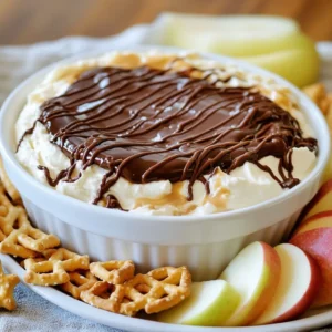 - 1 cup smooth peanut butter - 1 cup cream cheese, softened to room temperature - 1 cup powdered sugar - 1 teaspoon pure vanilla extract - 1 cup semi-sweet chocolate chips - 2 tablespoons coconut oil - Optional dippers: graham crackers, pretzels, apple slices Gather these ingredients before you start. Smooth peanut butter and cream cheese mix well. Softened cream cheese helps create a creamy dip. The powdered sugar adds sweetness. Pure vanilla extract enhances the flavor. The chocolate chips make a rich topping. Coconut oil gives the chocolate a smooth finish. You can use graham crackers, pretzels, or apple slices for dipping. Mixing these ingredients together creates a tasty treat. This dip is great for parties or snacks. You can enjoy it with family and friends. Everyone loves this sweet and creamy delight! {{ingredient_image_2}} - First, combine 1 cup of smooth peanut butter with 1 cup of softened cream cheese. - Next, beat the mixture with an electric mixer. Keep mixing until it is smooth and creamy. This should take about 2 to 3 minutes. - Gradually add 1 cup of powdered sugar to the peanut butter mix. - Then, add 1 teaspoon of pure vanilla extract. - Mix on low speed. You want the dip to be fluffy and light. - In a microwave-safe bowl, put 1 cup of semi-sweet chocolate chips and 2 tablespoons of coconut oil. - Heat these in the microwave for 30 seconds at a time. Stir well between each 30-second interval. - Keep heating until the mixture is completely melted and glossy. - Pour the melted chocolate over the peanut butter layer in your dish. Use a spatula to spread it evenly. - Now, place the dip in the refrigerator. Chill it for at least 30 minutes. This helps the dip firm up for better dipping. To get a creamy mix, use smooth peanut butter. It blends better and gives a silky feel. Choose a good brand with no added sugars. For the cream cheese, ensure it is softened. If it is too cold, it will be hard to mix. Let it sit at room temperature for 30 minutes before you start. This step helps create a smooth and fluffy dip. For a fun look, garnish the dip with crushed peanuts or chocolate shavings. This adds texture and a nice touch. You can also arrange your dippers in a circle around the dip. Use graham crackers, pretzels, or crisp apple slices. This makes it easy for guests to grab and enjoy. Buckeye Dip shines at parties and gatherings. It is great for game nights or holiday celebrations. Pair it with sweet and salty dippers. Graham crackers and pretzels work well together. Apple slices add a fresh crunch. This dip is sure to please everyone at the table! Pro Tips Use Room Temperature Ingredients: Ensuring your cream cheese is at room temperature will help achieve a smooth and creamy dip without lumps. Chocolate Melting Technique: When melting chocolate, always stir between intervals to prevent burning and achieve a smooth consistency. Chill for Best Texture: Allowing the dip to chill for at least 30 minutes will enhance its texture, making it easier to scoop with your dipping items. Customizable Dippers: Feel free to experiment with different dippers like fruit, cookies, or even potato chips for a unique flavor combination! {{image_4}} You can change the texture of your Buckeye Dip by using different kinds of peanut butter. Creamy peanut butter makes a smooth dip. Crunchy peanut butter adds fun bits. Try both to see which one you like best. For the chocolate topping, you can play around with your choices, too. Dark chocolate gives a richer flavor. White chocolate adds sweetness. Each option changes the dip's taste and look, so experiment! If you need gluten-free options, use gluten-free dippers like rice crackers or fresh veggies. They pair well with the dip's rich flavor. For those who want a vegan dip, swap the cream cheese for a plant-based version. You can find many tasty vegan cream cheeses that work great. This keeps the dip creamy while making it fit your needs. Want to make your dip pop? Add a pinch of sea salt to the mix. It brings out the sweetness and balances the flavors. You can also try adding spices like cinnamon. Just a small amount can give your dip a warm, cozy feel. This twist makes your Buckeye Dip even more special for snacks or parties. To keep your Buckeye Dip fresh, use a sealed container. This helps prevent air from getting in. If you don't have a container, cover it tightly with plastic wrap. Proper storage keeps flavors intact. You can store it in the fridge for up to five days. If you want to reheat the chocolate layer, do it gently. Use a microwave and heat in short bursts. Stir often to avoid burning. After refrigeration, the dip can become firm. To bring it back to life, let it sit at room temperature for a few minutes before serving. This helps maintain the creamy texture. Enjoy your dip as a tasty treat! Buckeye Dip is a creamy dessert dip inspired by the famous Buckeye candy. The dip mixes peanut butter, cream cheese, and powdered sugar. It has a rich, sweet taste that many love. You will find it topped with melted chocolate, giving it a nice finish. This dip's origins come from Ohio, where the Buckeye candy was created. The blend of flavors makes it a hit at parties and gatherings. Yes, you can prepare Buckeye Dip ahead of time. Make it a day before your event for the best flavor. Simply follow the recipe and chill it in the fridge. Cover the dip tightly with plastic wrap to keep it fresh. When it&rsquo;s time to serve, just take it out and enjoy. The flavors will blend beautifully, making it even tastier. You can safely leave Buckeye Dip out for about two hours. After that, it should go back in the fridge. If the room is warm, consider serving it in smaller portions. This way, you can keep the rest chilled. Always keep an eye on it to ensure food safety for your guests. If you need a substitute for cream cheese, try Greek yogurt or silken tofu. Both give a creamy texture without dairy. For a nut-free option, use sunflower seed spread. Each choice will change the flavor slightly, but they work well in the dip. You can enjoy Buckeye Dip even with different dietary needs. In this article, we explored how to make a tasty Buckeye Dip. You learned about the ingredients, easy steps, and tips for the best results. We looked at fun variations to fit different diets and preferences. Remember to store it in a sealed container for freshness. Now, you can impress your friends and family with this creamy treat. Enjoy it at your next get-together! Simple to prepare and fun to eat, Buckeye Dip is always a hit.
